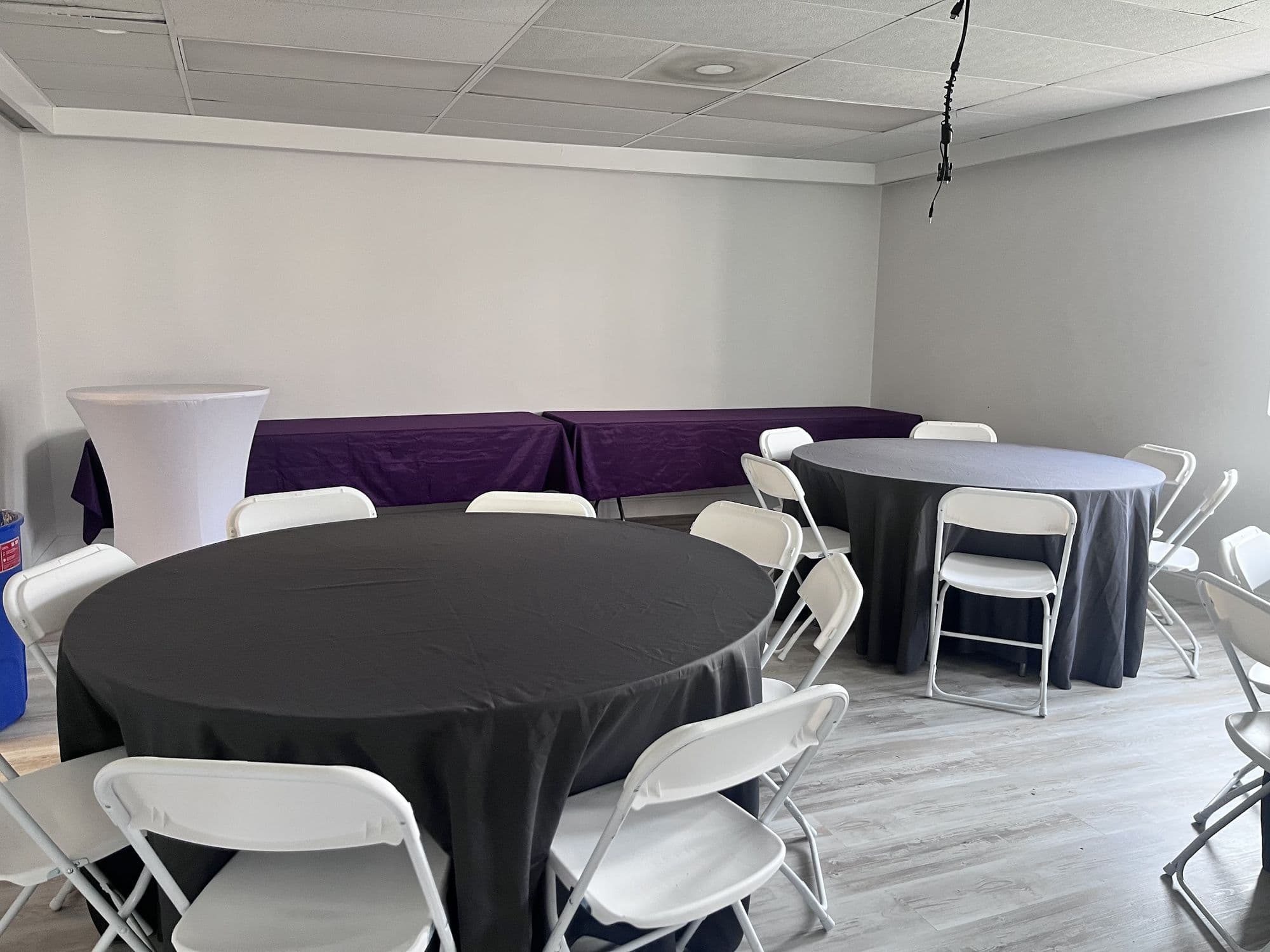 Round tables set in front of a buffet table wall at Buffalo Event Space