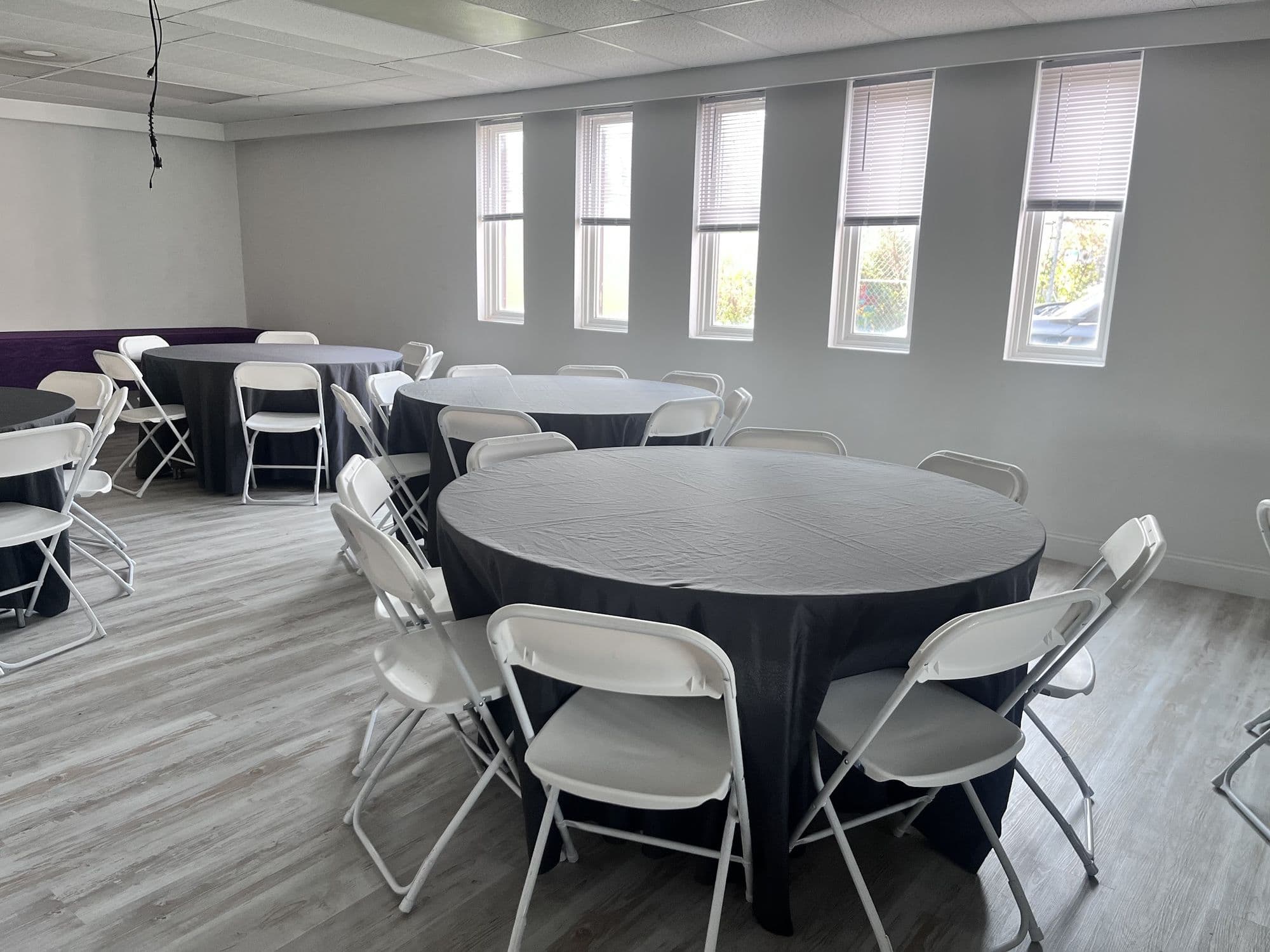 Natural light over round banquet tables at Buffalo Event Space
